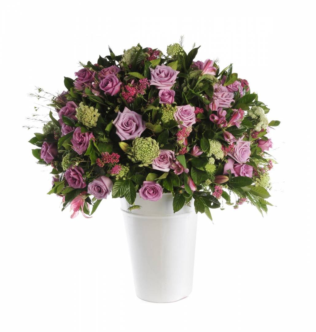 Composition with variety of flowers in a tall pot